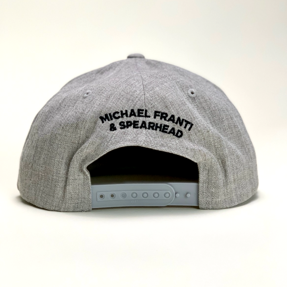 Gray snapback baseball cap with ’MICHAEL FRANTI & SPEARHEAD’ embroidered on the back.